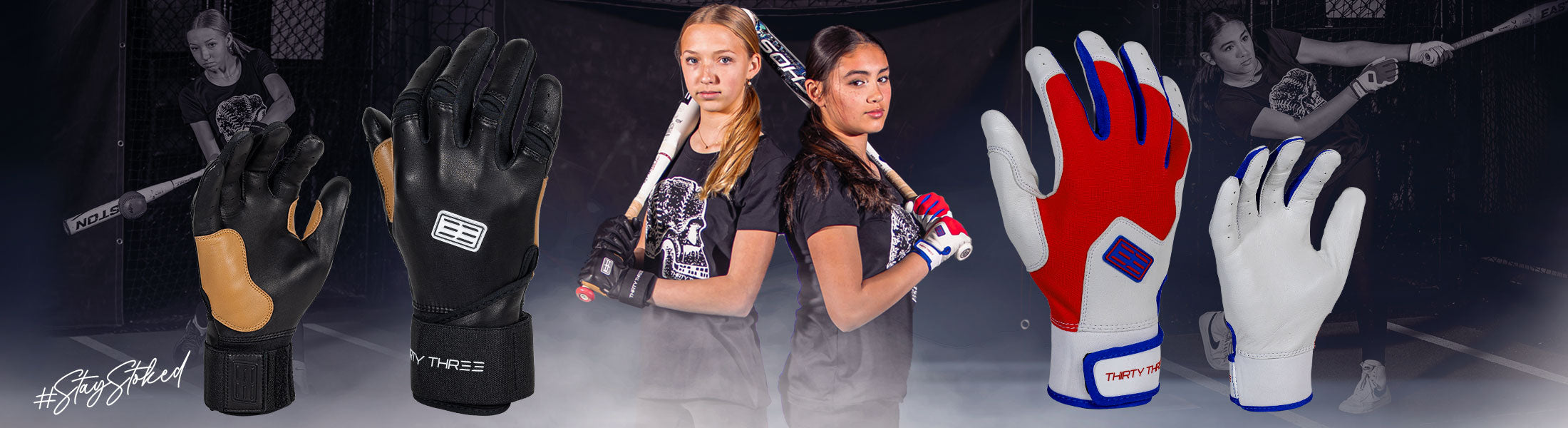 Batting gloves displayed with two softball players holding two softball bats in the background